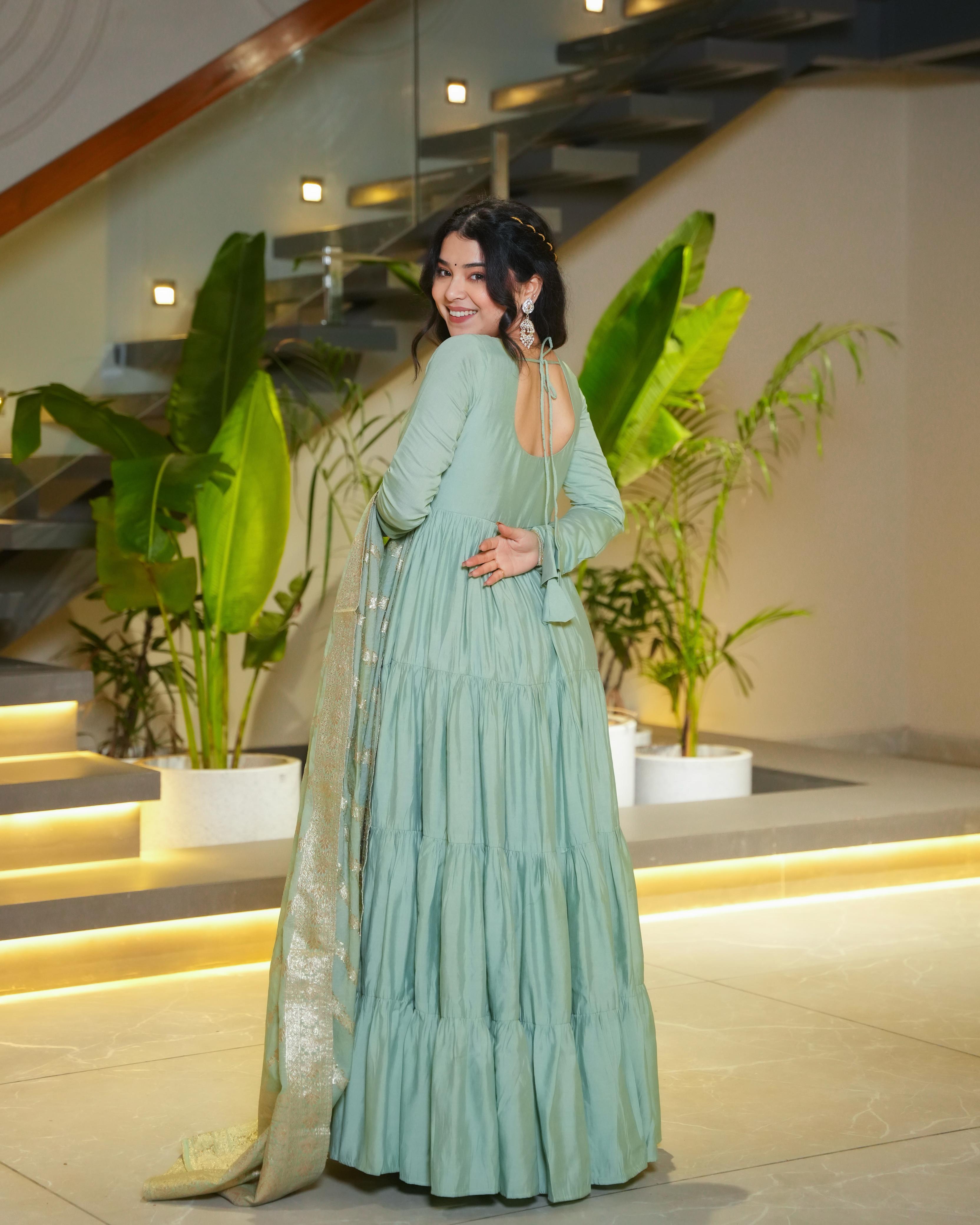 Pista green Roman silk Chanderi Anarkali suit set with Banarasi dupatta, flared Anarkali gown for wedding functions and festive wear, designer frill Anarkali with 9-meter flair, Chanderi silk ethnic suit for women, Banarasi dupatta suit for reception and party wear, pista color Anarkali dress for haldi, mehendi, or Eid, lightweight Anarkali kurta pant set with traditional embroidery.
